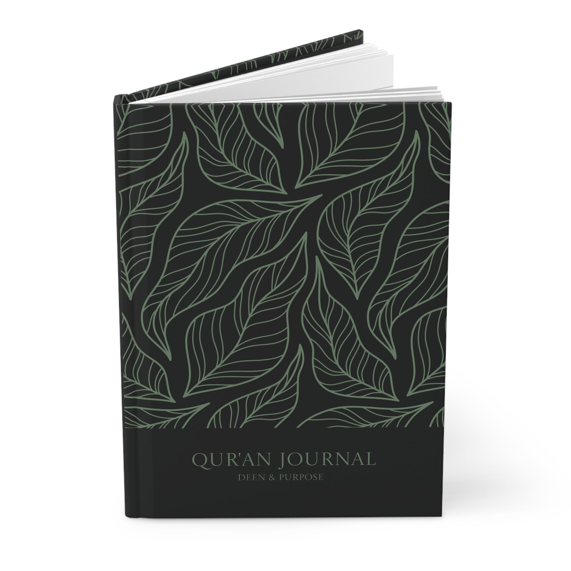 Angled view of a black Quran journal with sage green leaf pattern and hardcover finish.