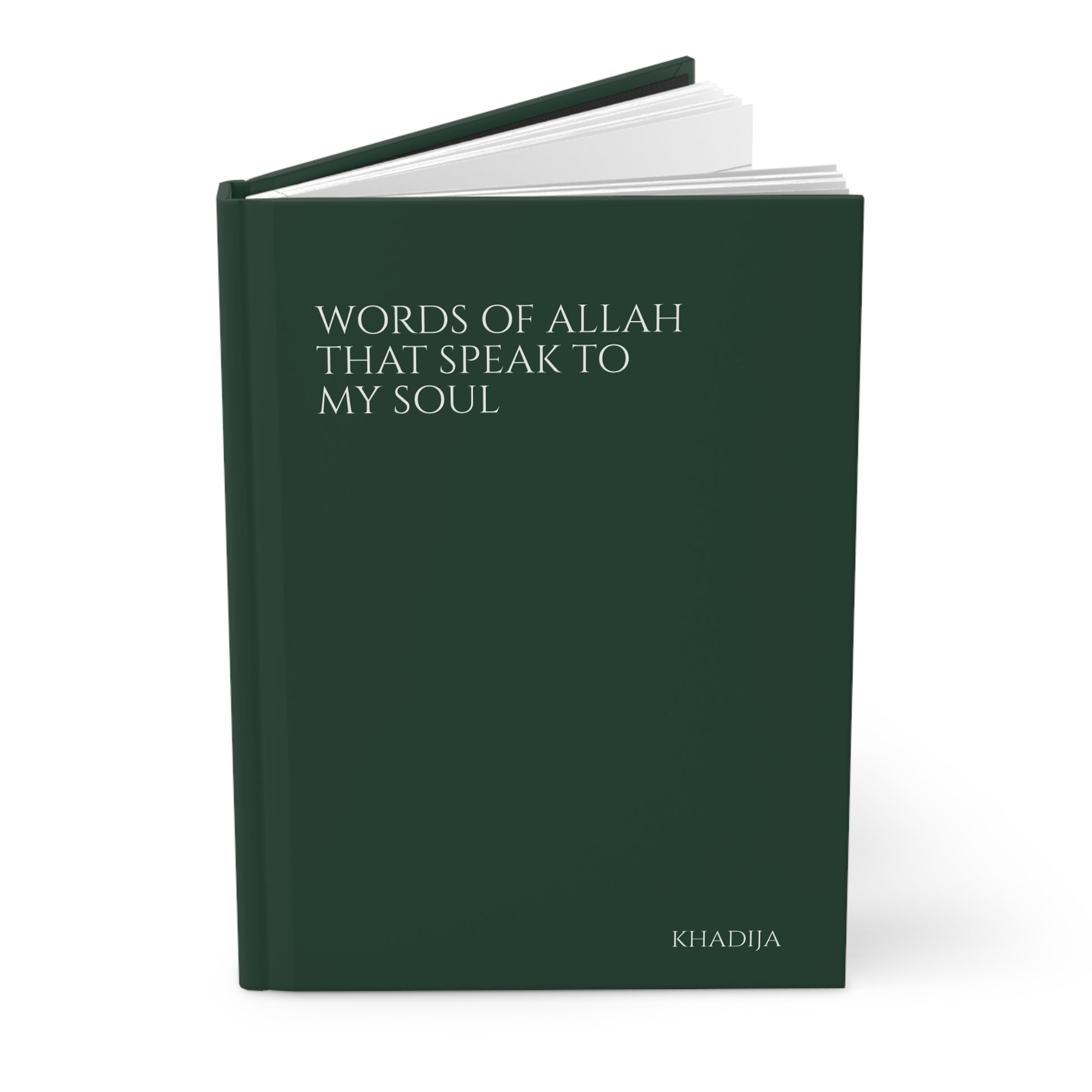 Angled view of a dark green Quran journal with smooth hardcover finish and simple text layout.