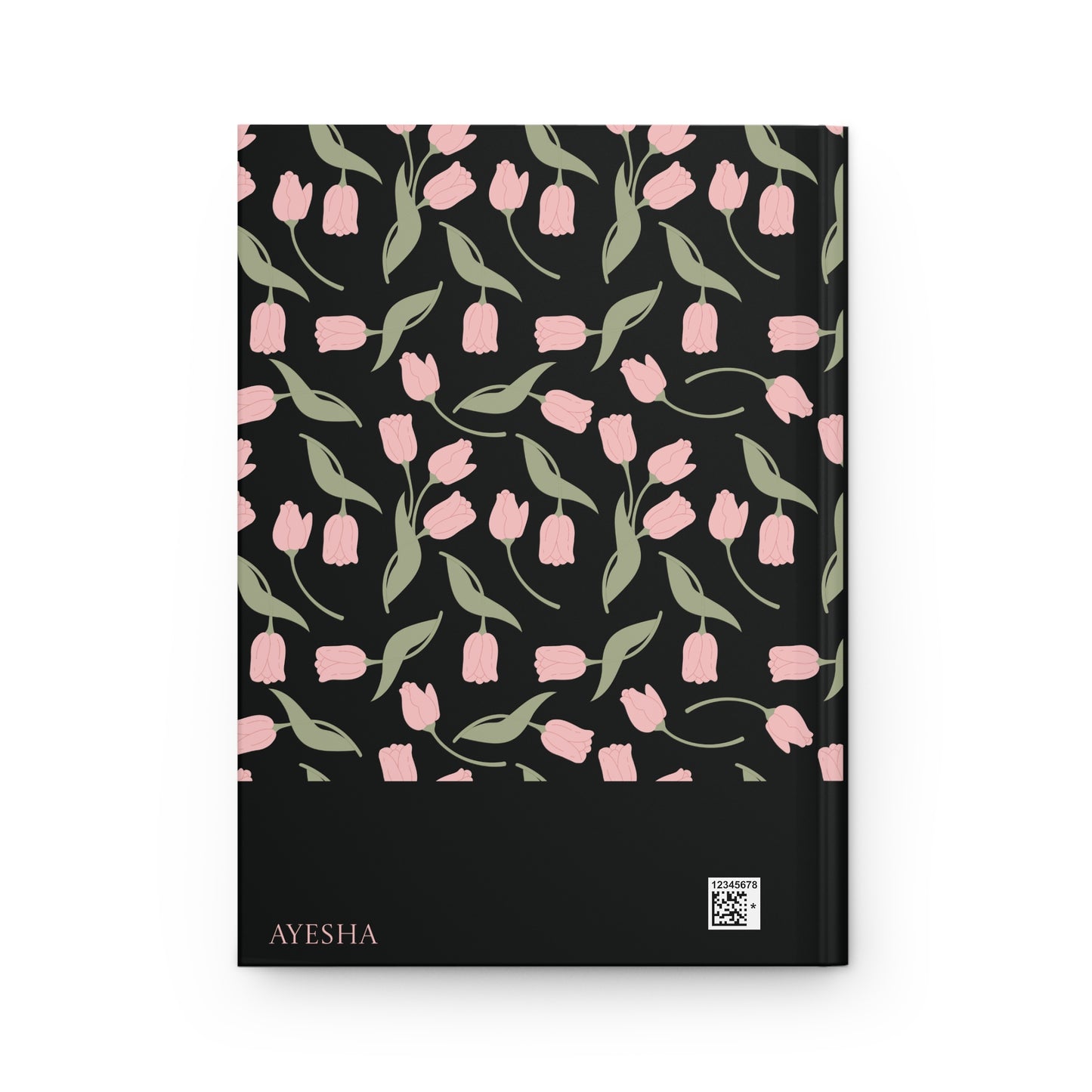 Back cover of a black Qur'an journal with a personalizable name "AYESHA".  The back cover features soft pink floral and leaf artwork.