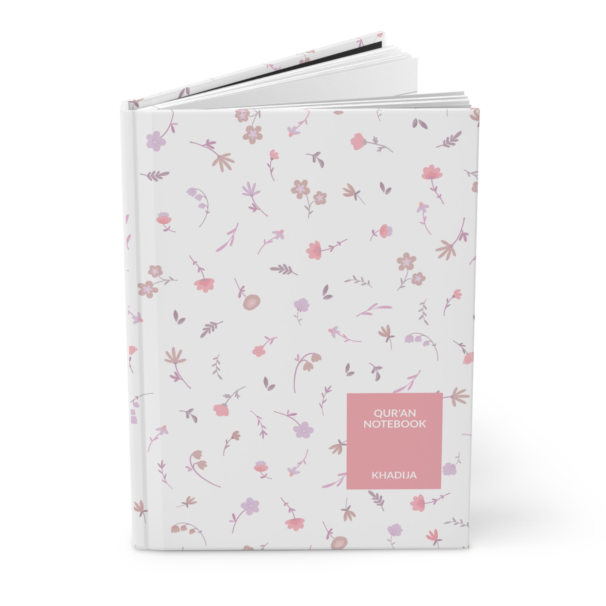 Angled view of a Quran notebook with floral pattern and hardcover finish.