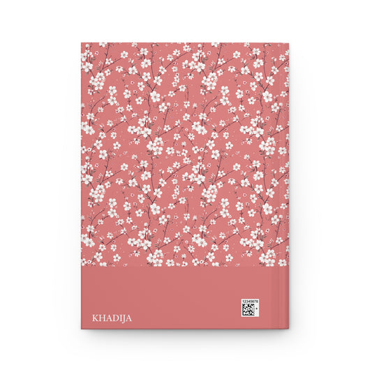 Revert journal with white floral pattern on a pink cover, with personalizable name 'KHADIJA' visible.