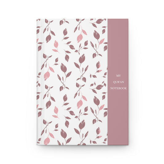 Front cover of a Quran notebook with soft pink and mauve leaf pattern and minimalist title panel.