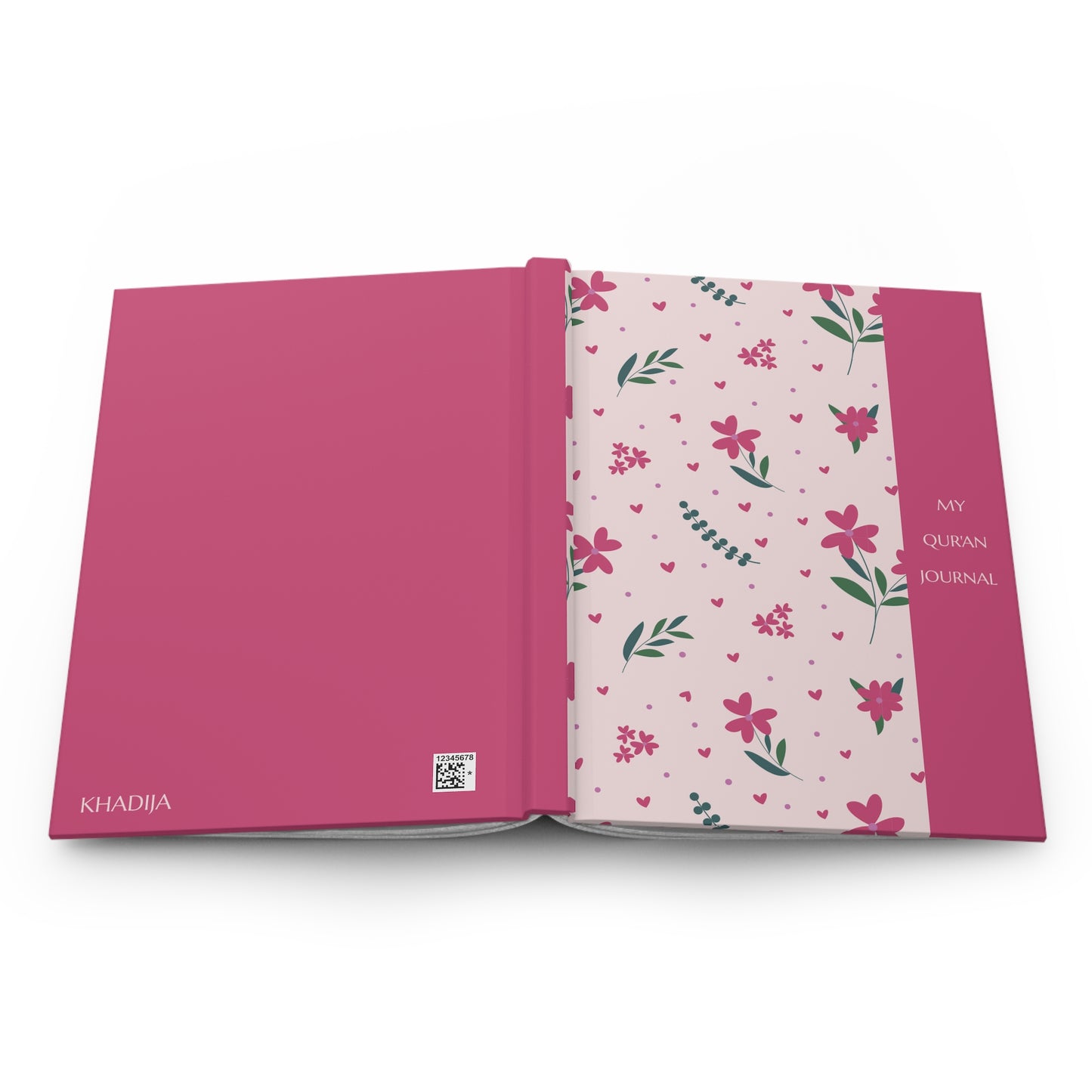 Pink Quran journal with floral design on a white background